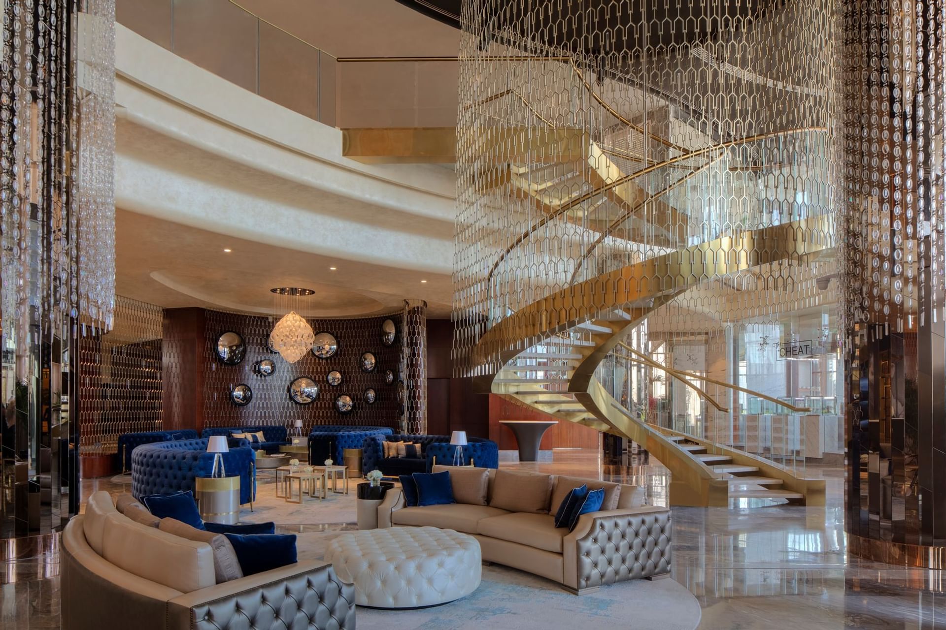 Luxury lobby lounge area with a spiral stairway at Paramount Hotel Dubai