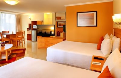 Twin beds with a TV in Master Suite at Araiza Hotel Palmira