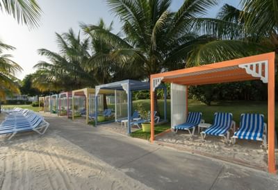 Cabanas with sunbeds on the beach at Holiday Inn Montego Bay