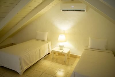 Cozy Superior Room at La Casita by the Hub, offering comfortable accommodation in Bayahibe, with two single bed
