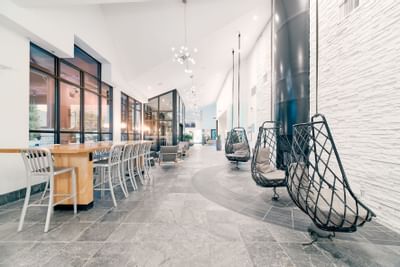 Rattan hanging egg chairs in hotel lobby at Aava Whistler Hotel