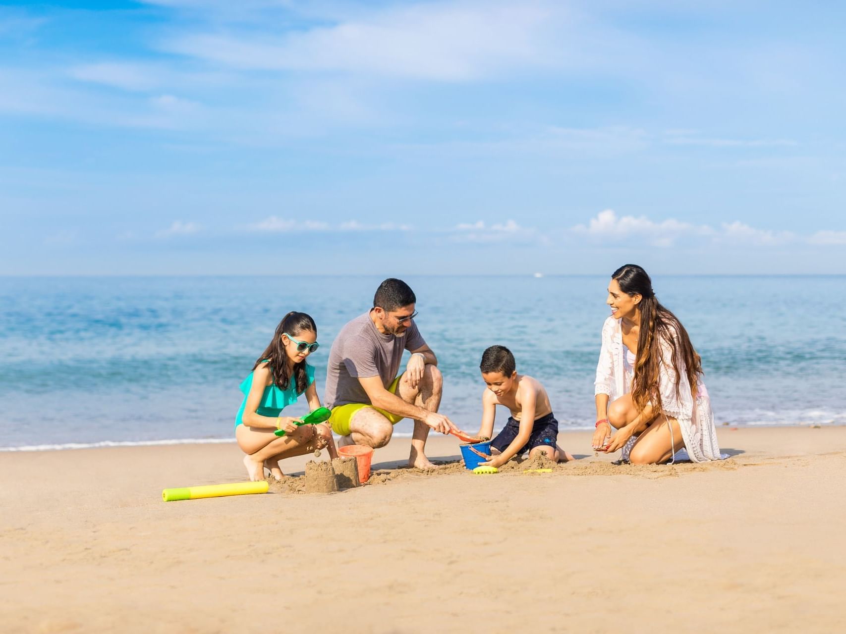 Family having fun on a sandy beach near Buenaventura Grand Hotel and Spa