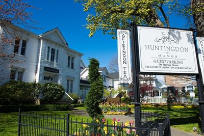 Landscape of hotel entrance & well-maintained garden at Huntingdon Manor