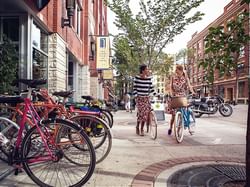 Two Girls cycling on 4th Street Promenade near Varscona Hotel on Whyte