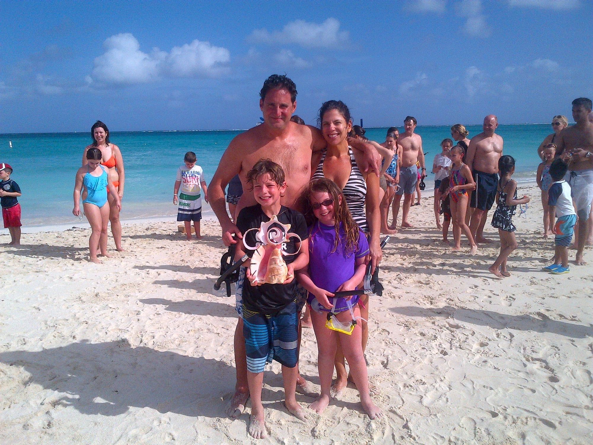 Family posing at the beach near The Somerset on Grace Bay
