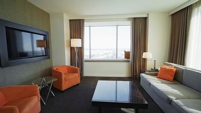 a couch facing a wall mounted tv
