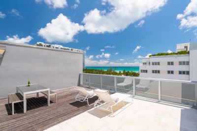 terrace with lounge chairs, picnic table and ocean view