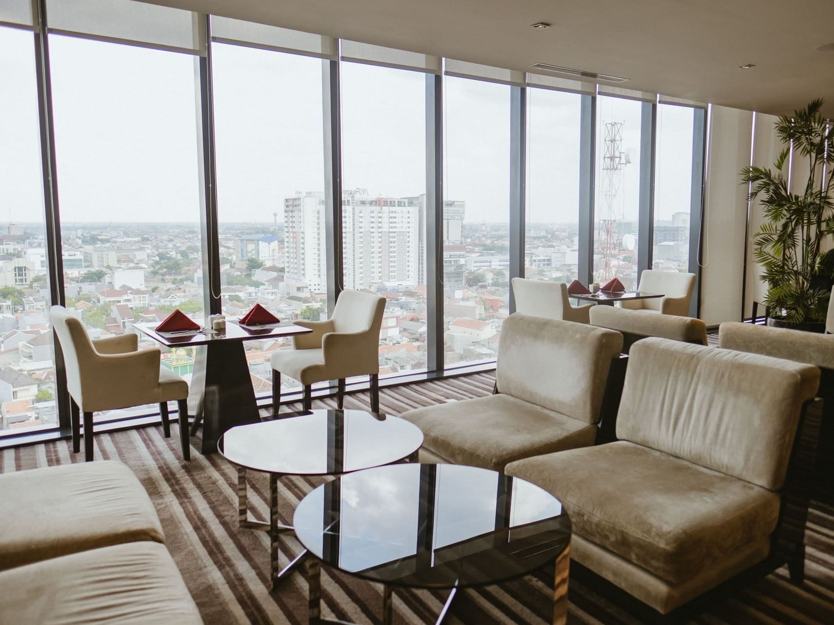 Dining table arranged in Club Lounge with a city view at Po Hotel Semarang