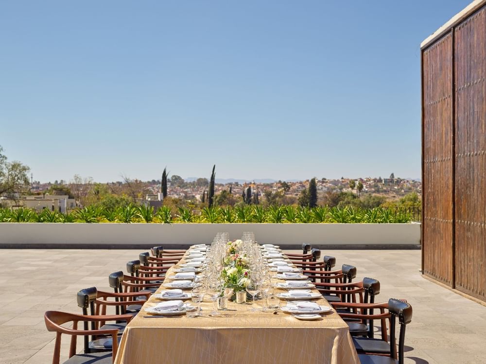 Outdoor royal banquet table arranged with glassware & floral decor at Live Aqua Resorts and Residence Club