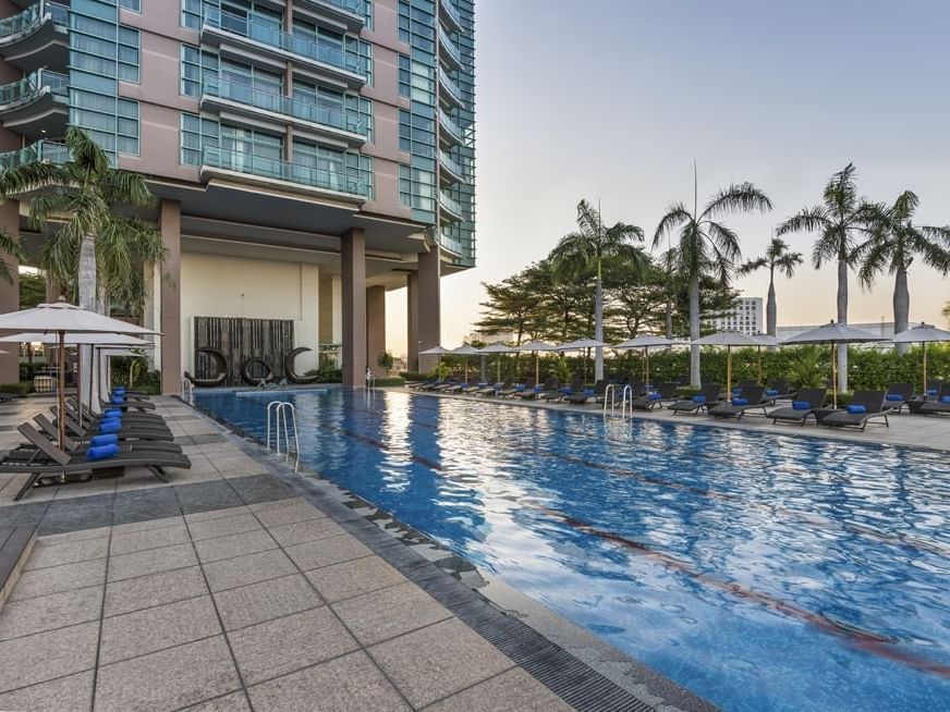 Outdoor pool & sunbed area at Chatrium Hotel Riverside Bangkok