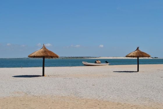 Straw beach umbrellas on the Beach in Angola, Presidente Luanda