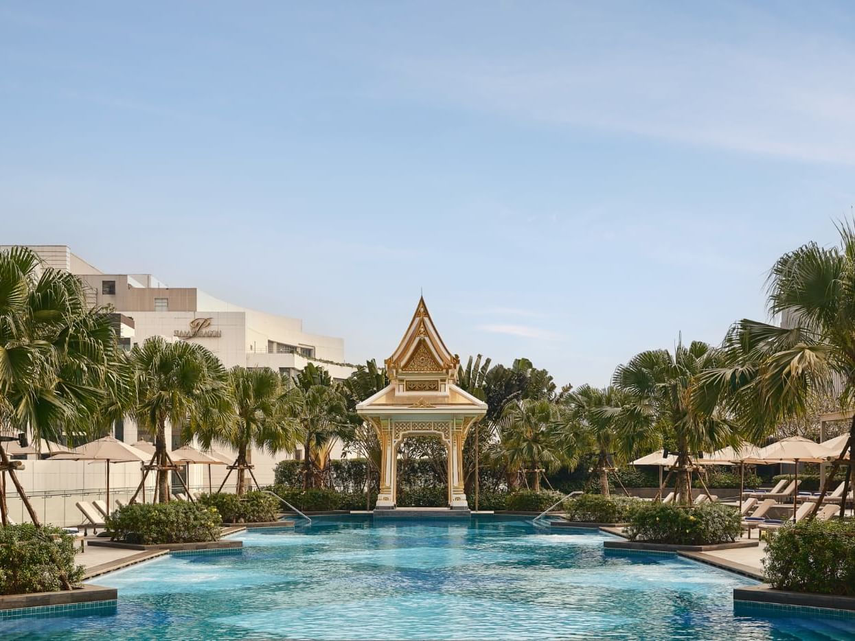 Outdoor pool with sun loungers at Chatrium Grand Bangkok