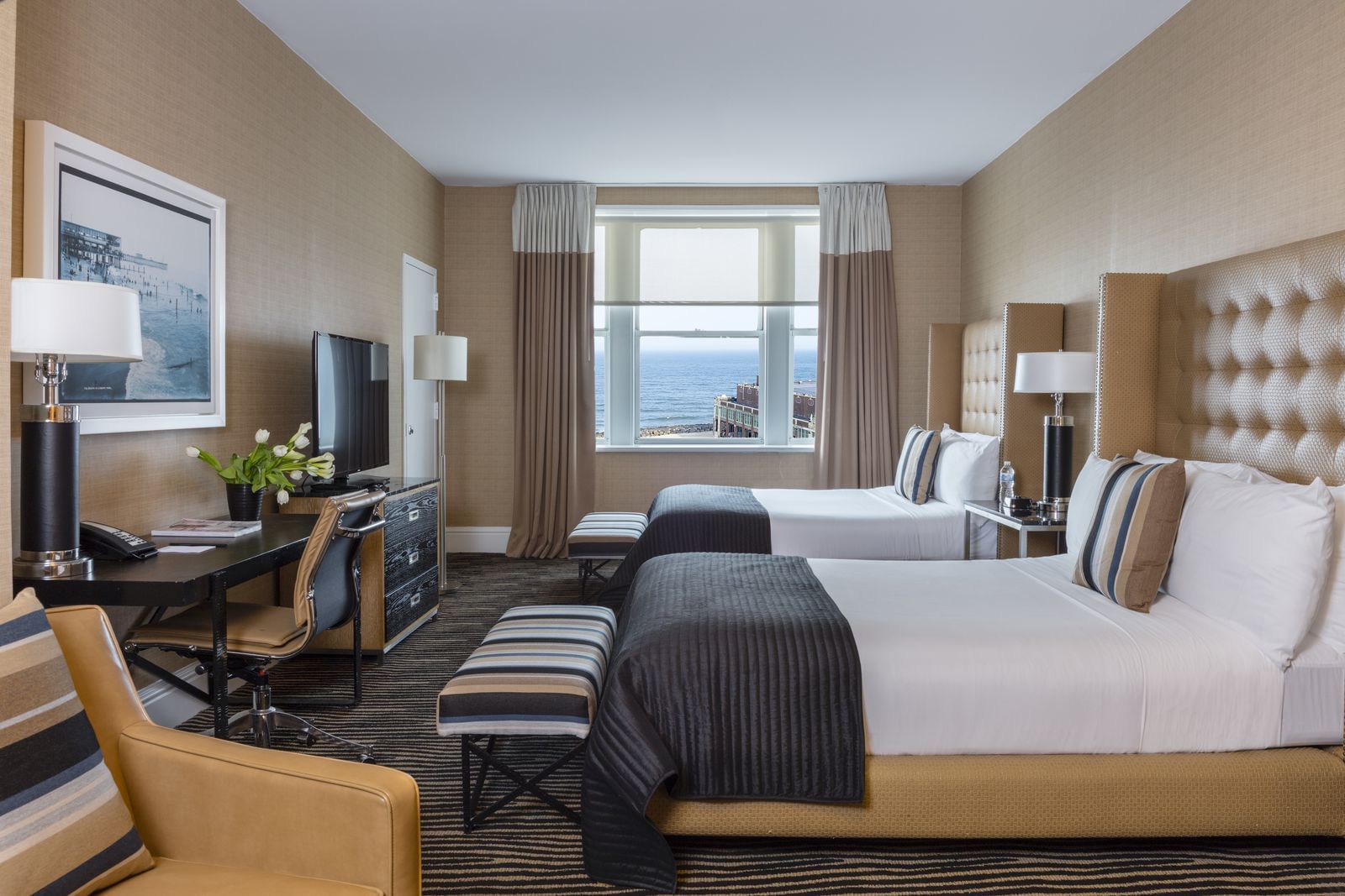 two beds and a desk in a hotel room