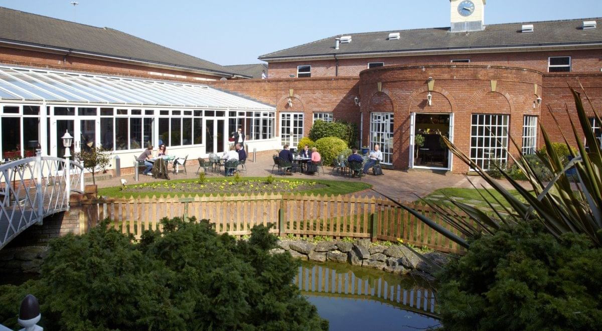 Exterior view of the Hotel Chester St Davids by a lake