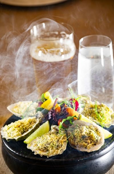 Steamy seafood dish with a glass of beer and water at Ellipse Grace Bay