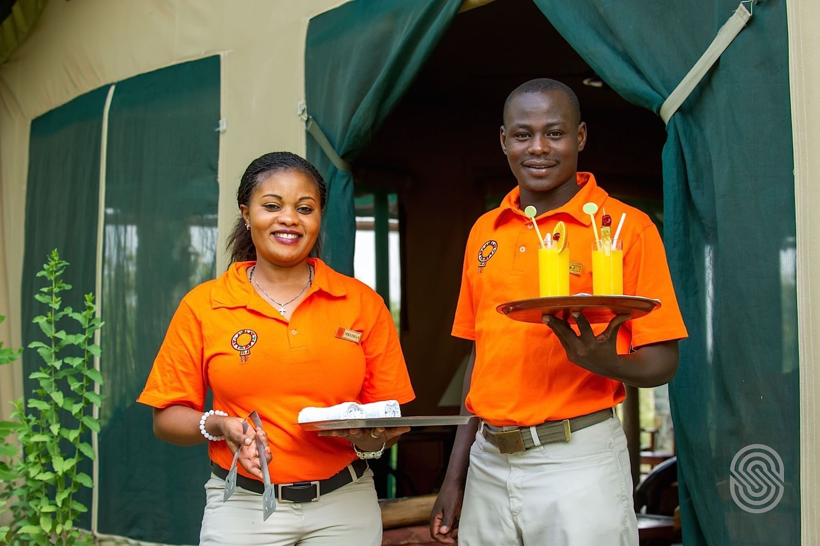 Two waiters serving fresh juices at Mbuzi Mawe Serena Camp