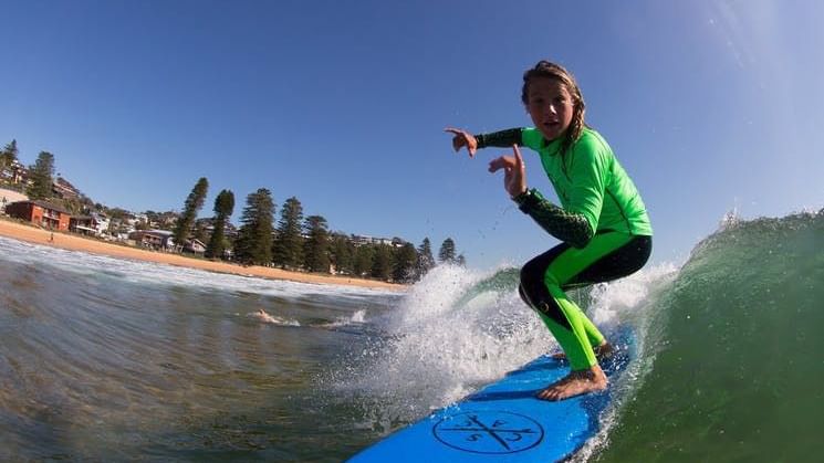 Girl surfing in Central Coast Surf Academy near Pullman Magenta Shores