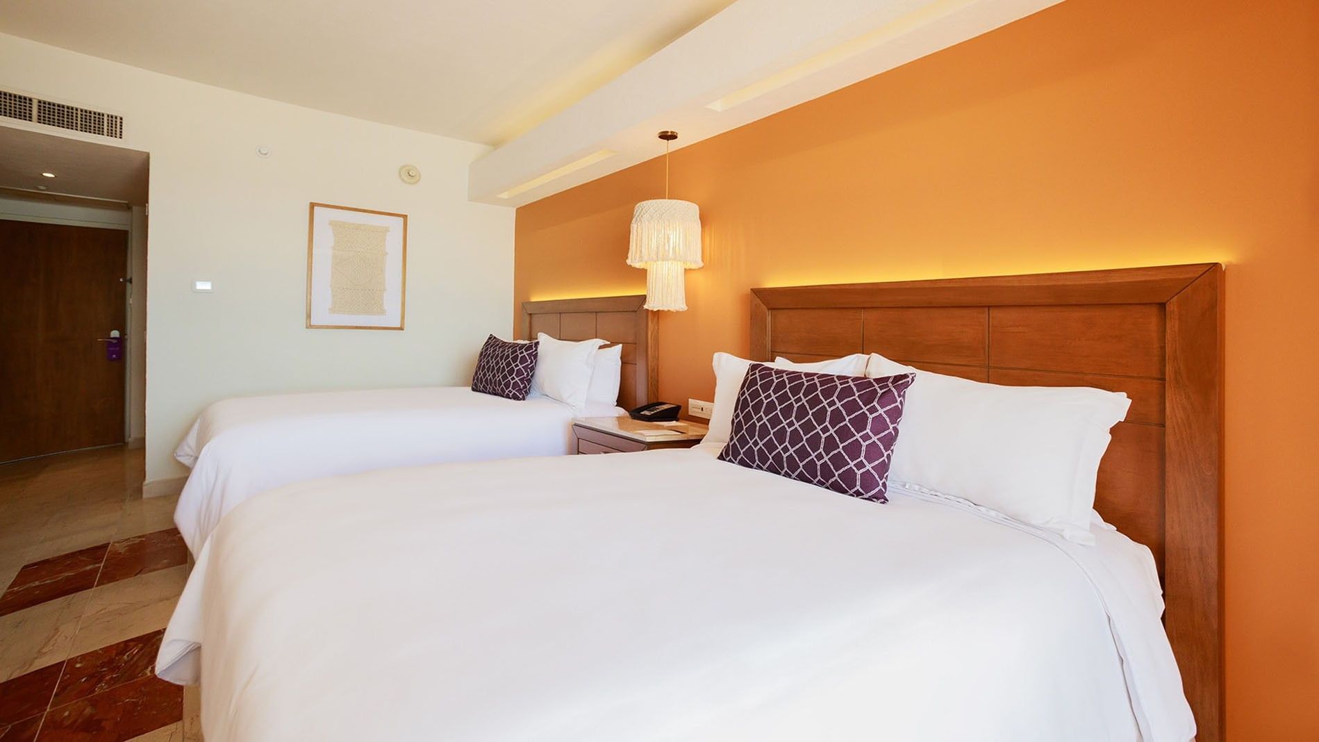 2 Double Deluxe Superior with white bedding, purple accents, and soft ambient light from lamps at Camino Real Veracruz