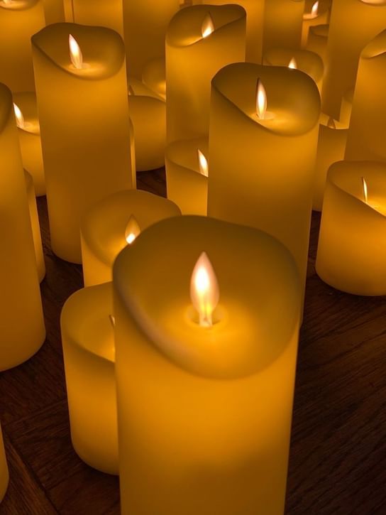 Close-up of wooden floor with lit yellow candles at Oceania Hotels