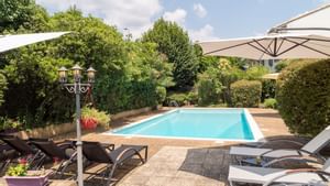 View of the outdoor pool & loungers at Originals Hotels