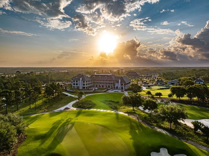 Aerial view of the hotel with lush greenery and golf course nearby at Camp Creek Inn