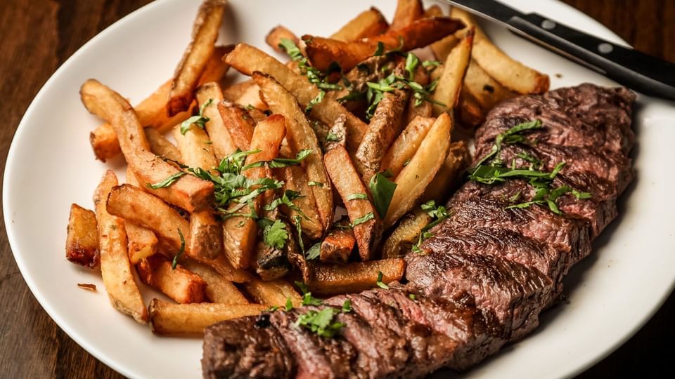 Close-up of a stake & fries dish served at Music Road Resort