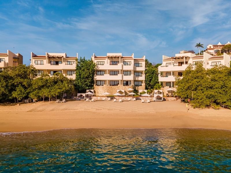 Beach & hotel exterior of Celeste Beach Residences Curamoria