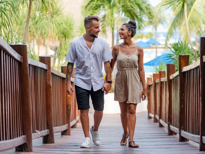 A couple walking through on the deck at The Reef Coco Beach