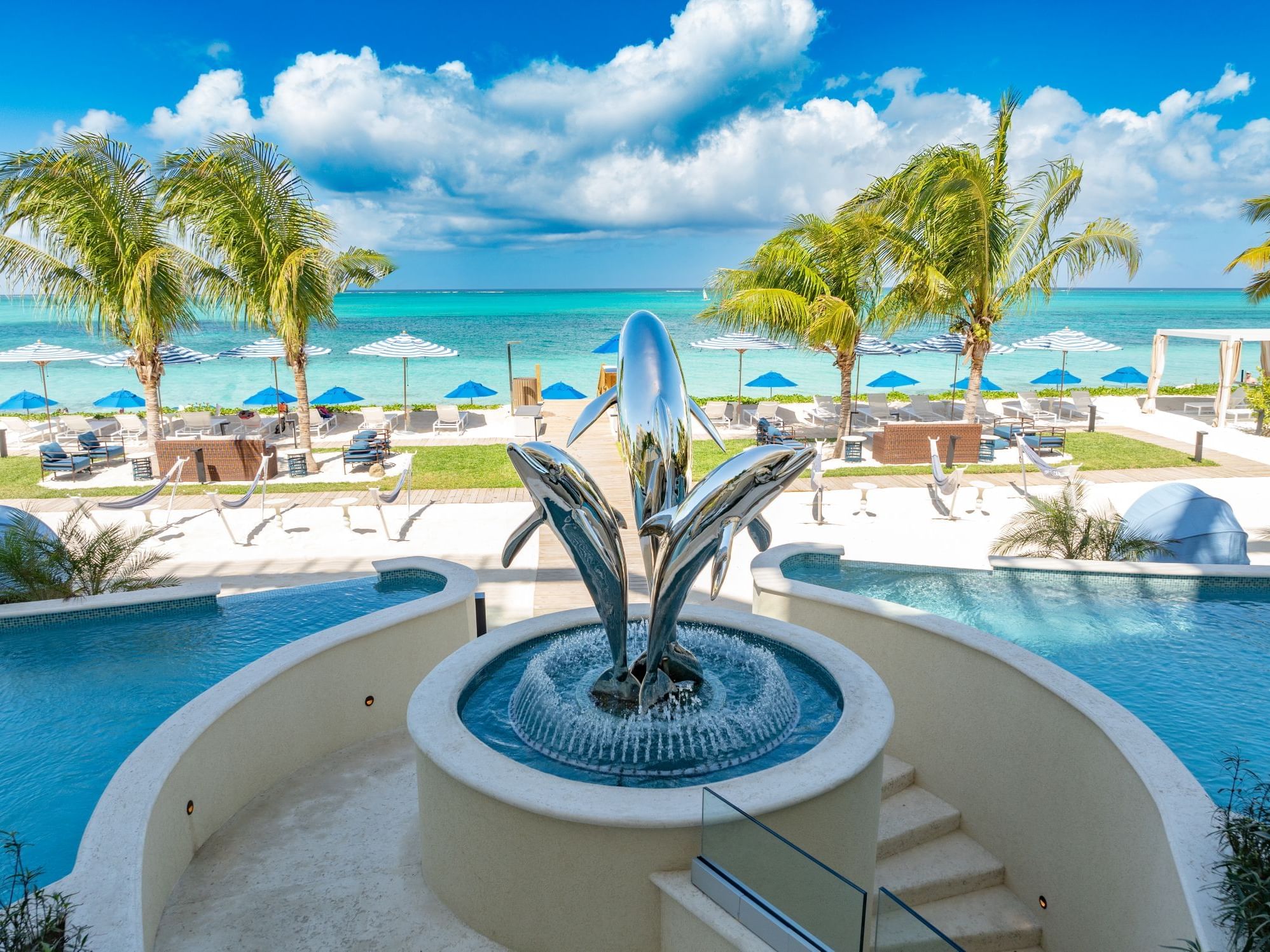 Windsong Resort On The Reef featuring a pool with fountain overlooking stunning beach in the background