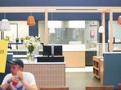 People dining at La Trobe University Glenn College open kitchen.