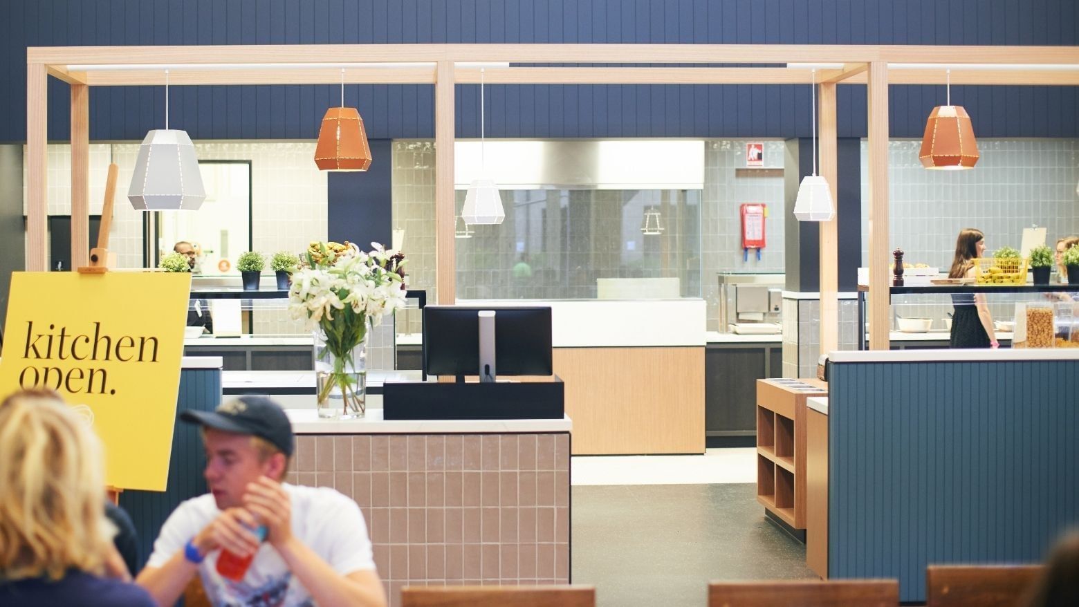 People dining at La Trobe University Glenn College open kitchen.