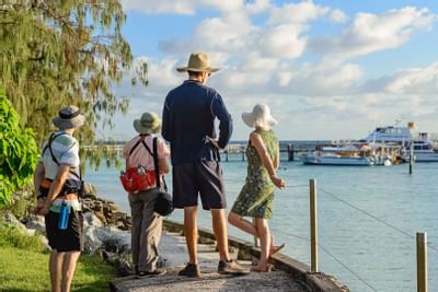 People looking at the pier in distant at Heron Island Resort