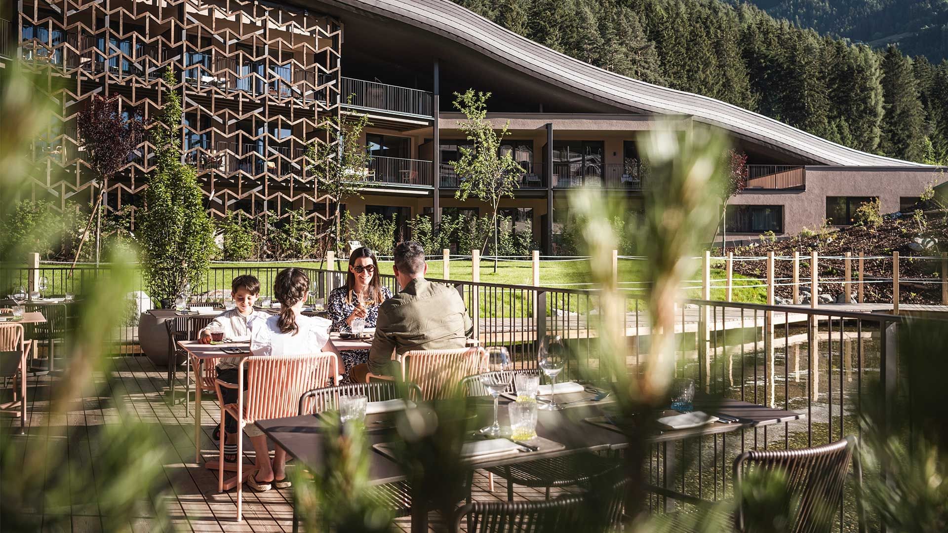 Family having meal in restaurant terrace outside at Falkensteiner Family Resort Lido