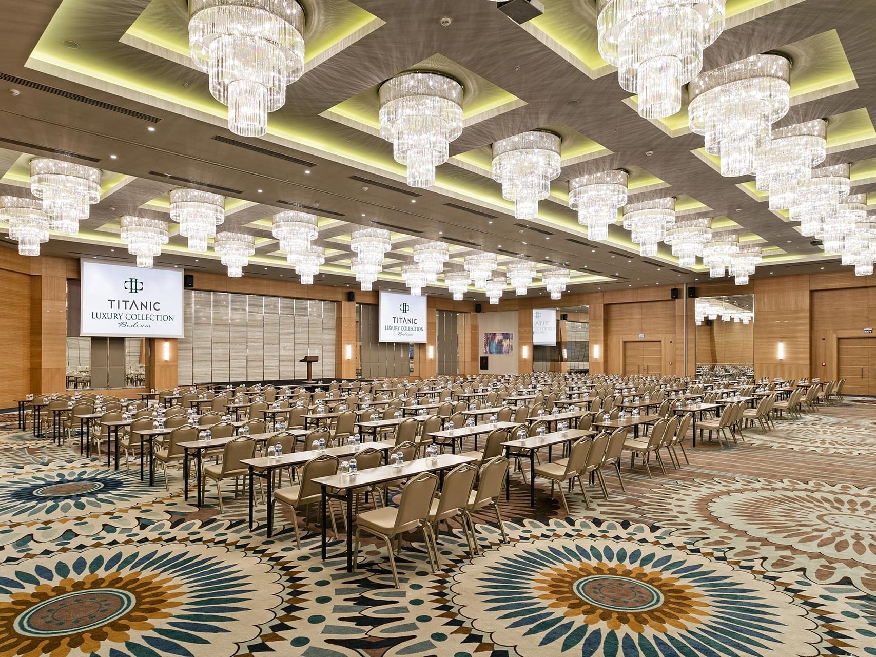 Luxurious conference hall with grand chandeliers and decorative carpets at Titanic Luxury Collection Bodrum.
