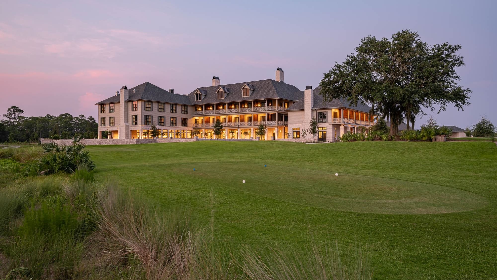 Golf course with a large mansion in the background and the Four-Star Celebration Package offer.