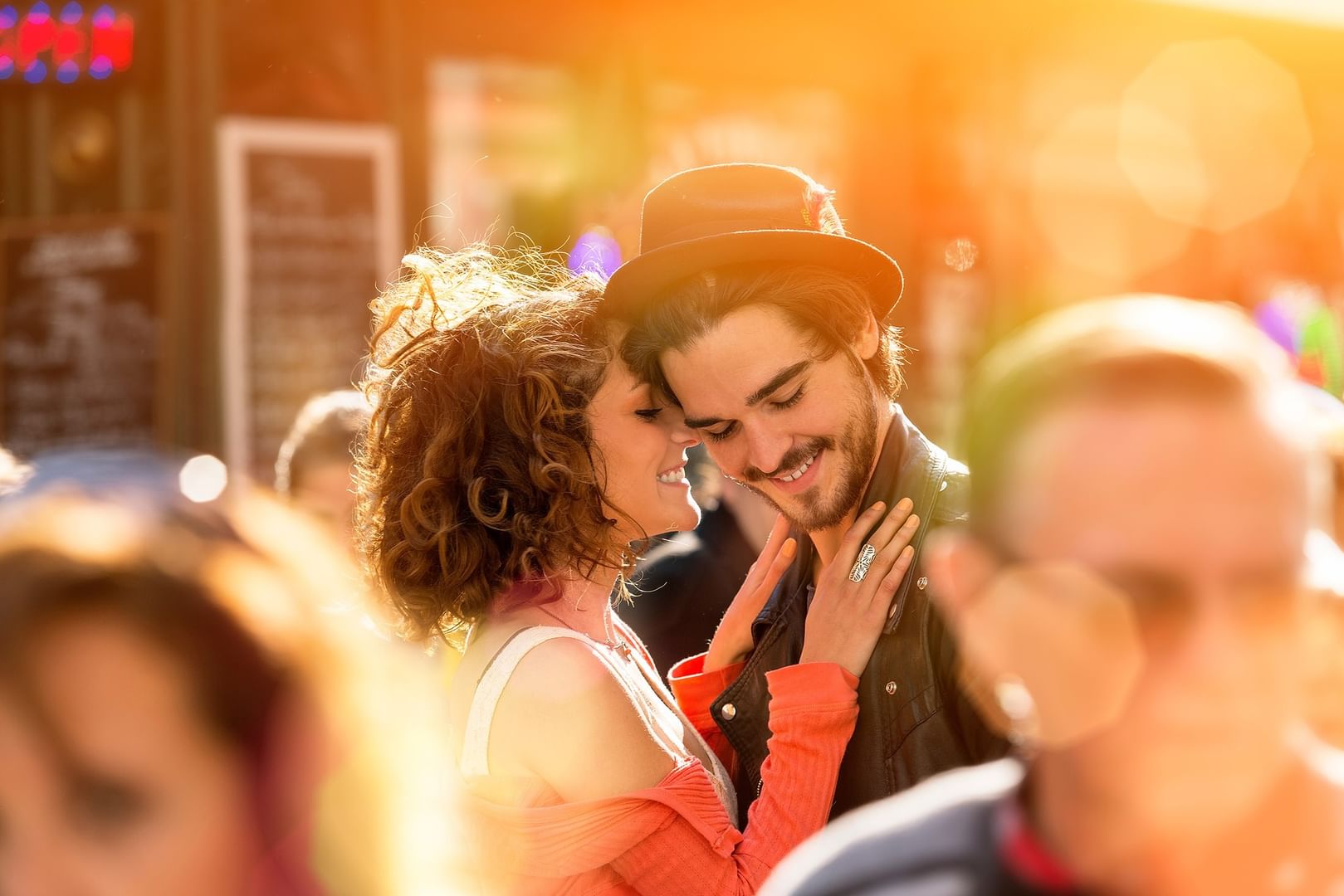 Smiling couple by a street cafe under golden sunlight at Warwick Paris Champs Elysées