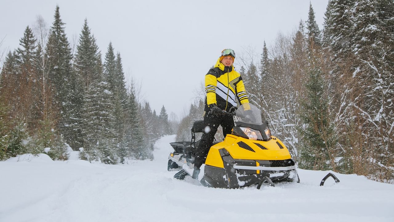Man on a yellow snowmobile at Whitecourt Trailblazers Snowmobile Rally.
