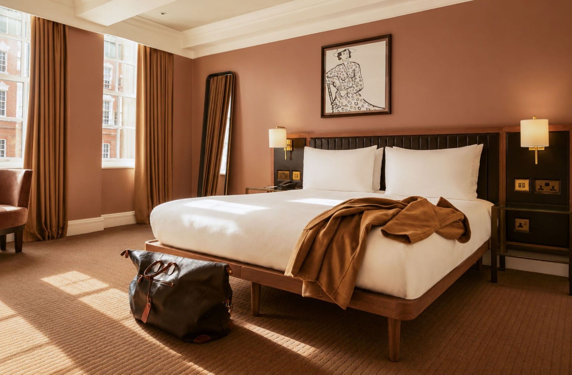 Sunlit Collection Premium Room with king bed, terracotta walls, floor mirror, and artwork at The May Fair Hotel, London.