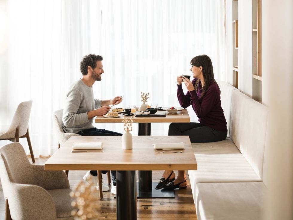 Couple dining at a restaurant at Falkensteiner Hotel Falkensteinerhof in Valles.
