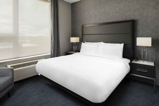 a bed and side table in a hotel room