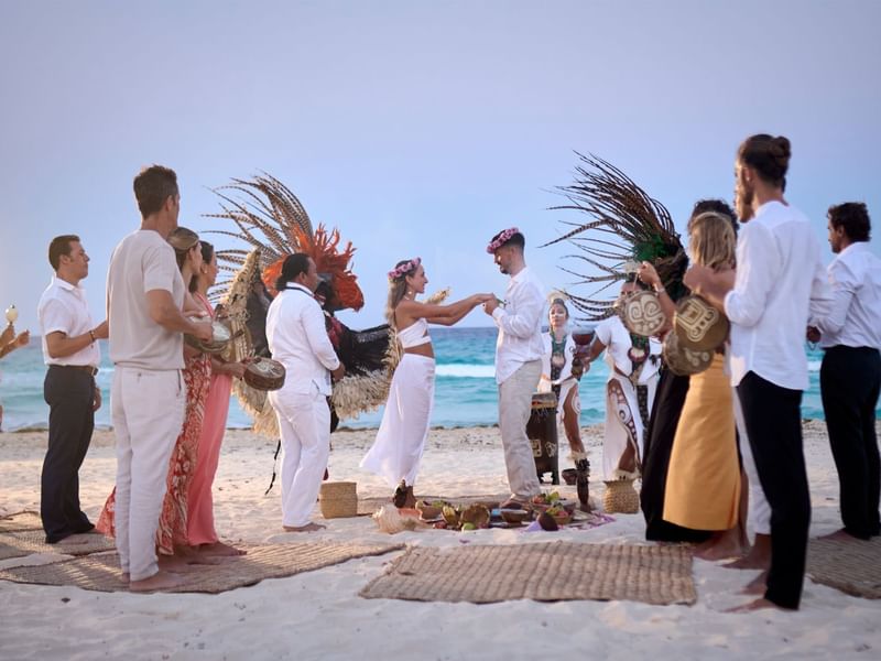 A beach wedding with guests at Grand Fiesta Americana