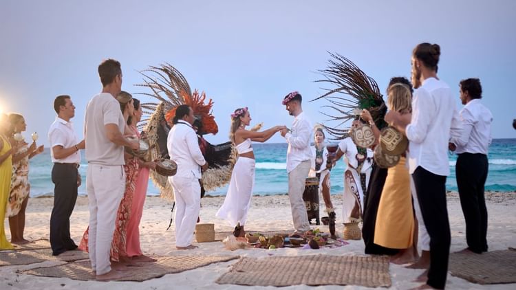 A beach wedding with guests near Grand Fiesta Americana Hotel and Resorts