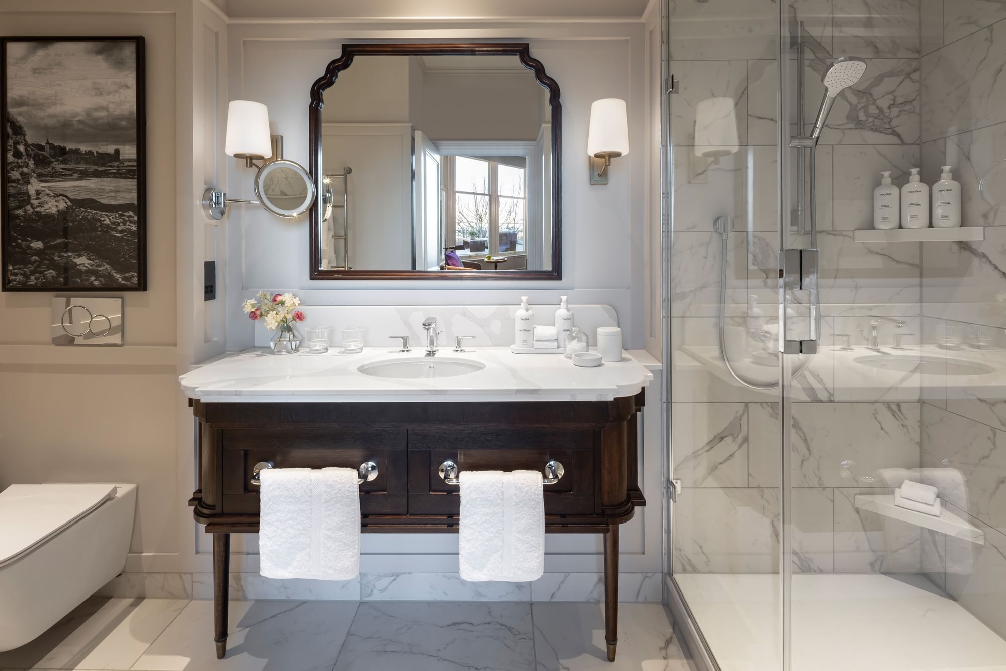Deluxe bathroom with a marble vanity, glass shower, large mirror, and neatly placed white towels below at Seaton House 