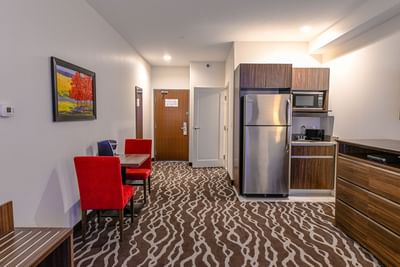 Interior view of Mini Queen Suite with kitchenette at Encore Suites Grande Prairie