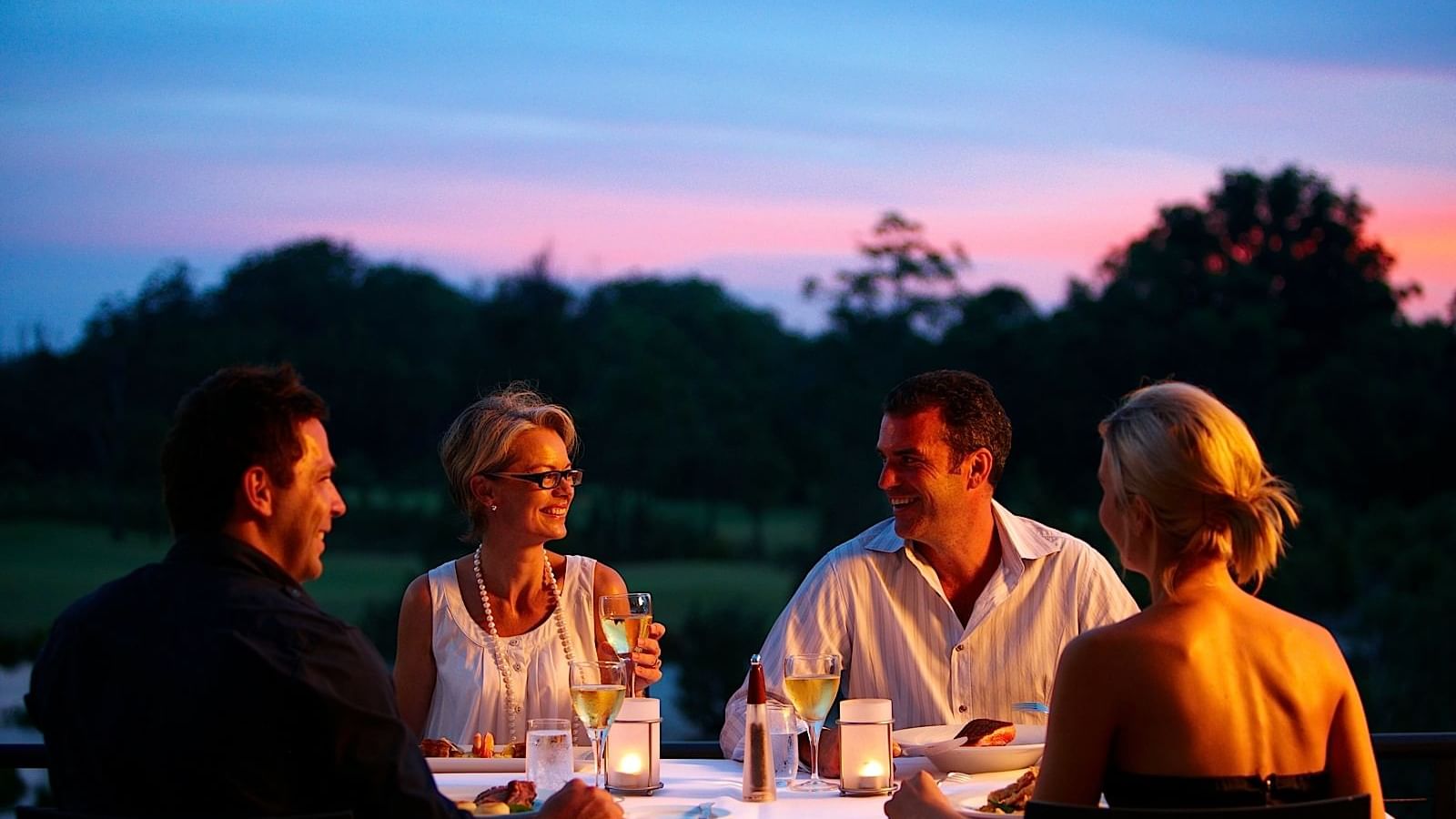 Four people having meals outside of Mercure Kooindah Waters