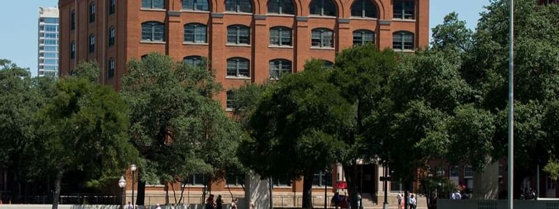 The historic red-brick building of the Sixth Floor Museum surrounded by trees near Warwick Melrose Hotel Dallas Ballroom
