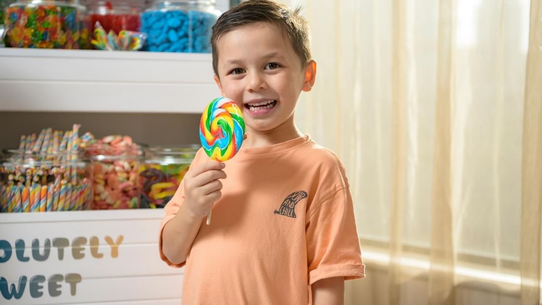 Boy enjoying candy in front of candy cart at Pullman Sydney Hyde Park