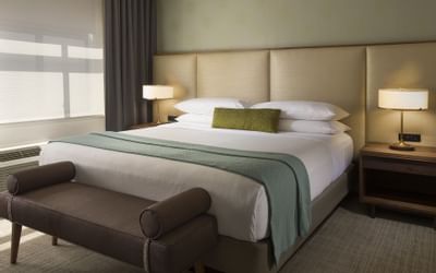 Cozy bed & nightstands in Cosmopolitan at Paramount Hotel Seattle