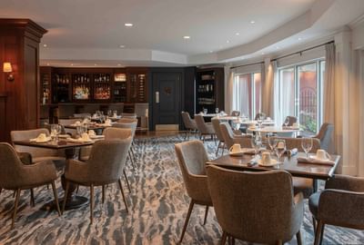 Bar counter by dining area in Harbor Bistro at Portland Harbor Hotel