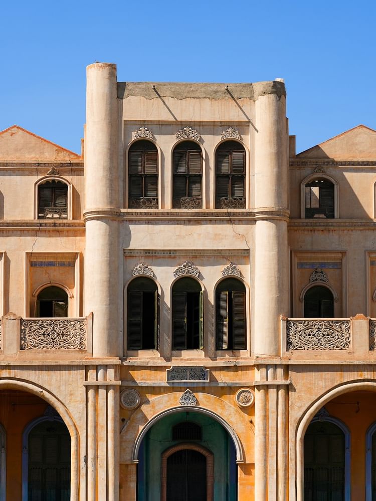 Grand architecture of the historic Al-Manial Palace, featuring ornate balconies and arched near Warwick Hotels & Resort